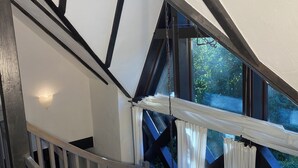 A staircase with a wooden railing, a white wall, and a window with curtains. - Landhaus Szczecin Lagoon, house3 (Dargen)