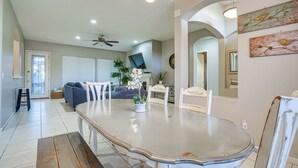 A dining area with a large table, chairs, and a ceiling fan. - Goodyear Group Getaway w/ Pool & Putting Green (Goodyear)