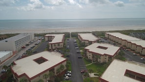 Guests enjoy ocean views from this coastal hotel's buildings, surrounded by lush greenery and offering convenient parking options.