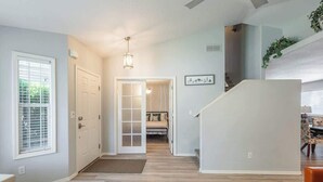 A spacious hallway with a staircase leading to a bedroom. - Upscale House with Outdoor Seating/Firepit (Boise)