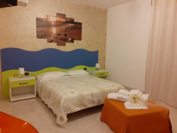 Relax in a cozy space with a comfortable bed, nightstands, and a small table.
