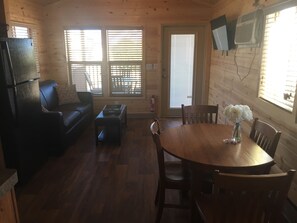 Deluxe Chalet | Living area | Books - Kingman KOA (Kingman)