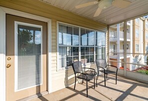 Relax in this serene outdoor seating area with a pair of chairs and a small table.