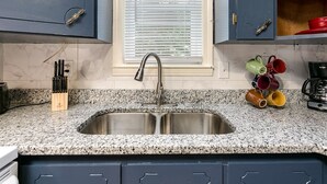 A kitchen with a double sink, a knife block, and a mug rack. - Down town Travelers rest walking to swamp rabbit bike trail  (Travelers Rest)