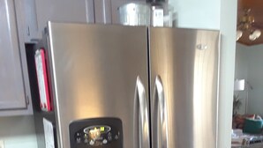 A stainless steel refrigerator with a built-in ice maker, a small drawer, and a freezer compartment. - Peaceful Lakefront Getaway, Stunning Sunsets & Waterfront Relaxation (Keystone Heights)