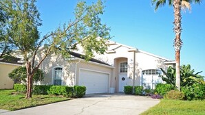 A single-story house with a white garage door, a front entrance, and a small porch area.