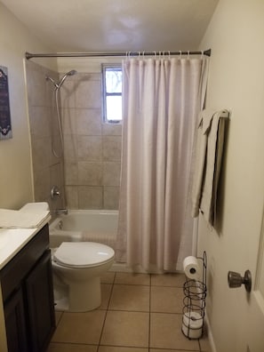 Bathtub, hair dryer, towels, soap