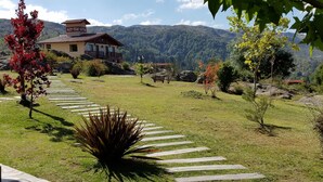 Un sentier menant à un b âtiment avec une montagne en arrière-plan.