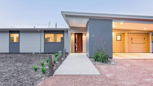 A modern two-story house with a visible garage door, a front entrance, and a well-maintained garden area. - Piper—Family Retreat in the Heart of Wine Country (Wilyabrup)