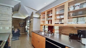 Eine Küche mit Holzausstattung, einem Spülbecken und einem Geschirrspüler.