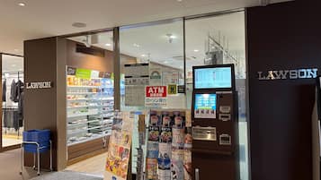 A Lawson store with an ATM and a money exchange machine.