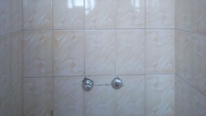 A tiled shower enclosure with a single showerhead mounted on the wall. - 3 Shades Annex - Adults Only (Thika)