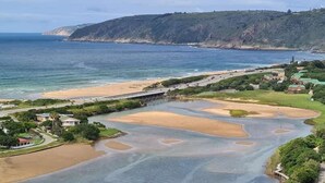 A coastal area with a beach, a bridge, and a golf course. - The Tops (Wilderness)
