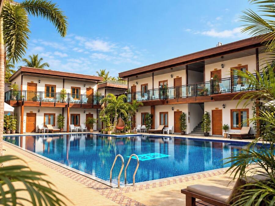 Un hotel con piscina, varios balcones y zonas de estar al aire libre.