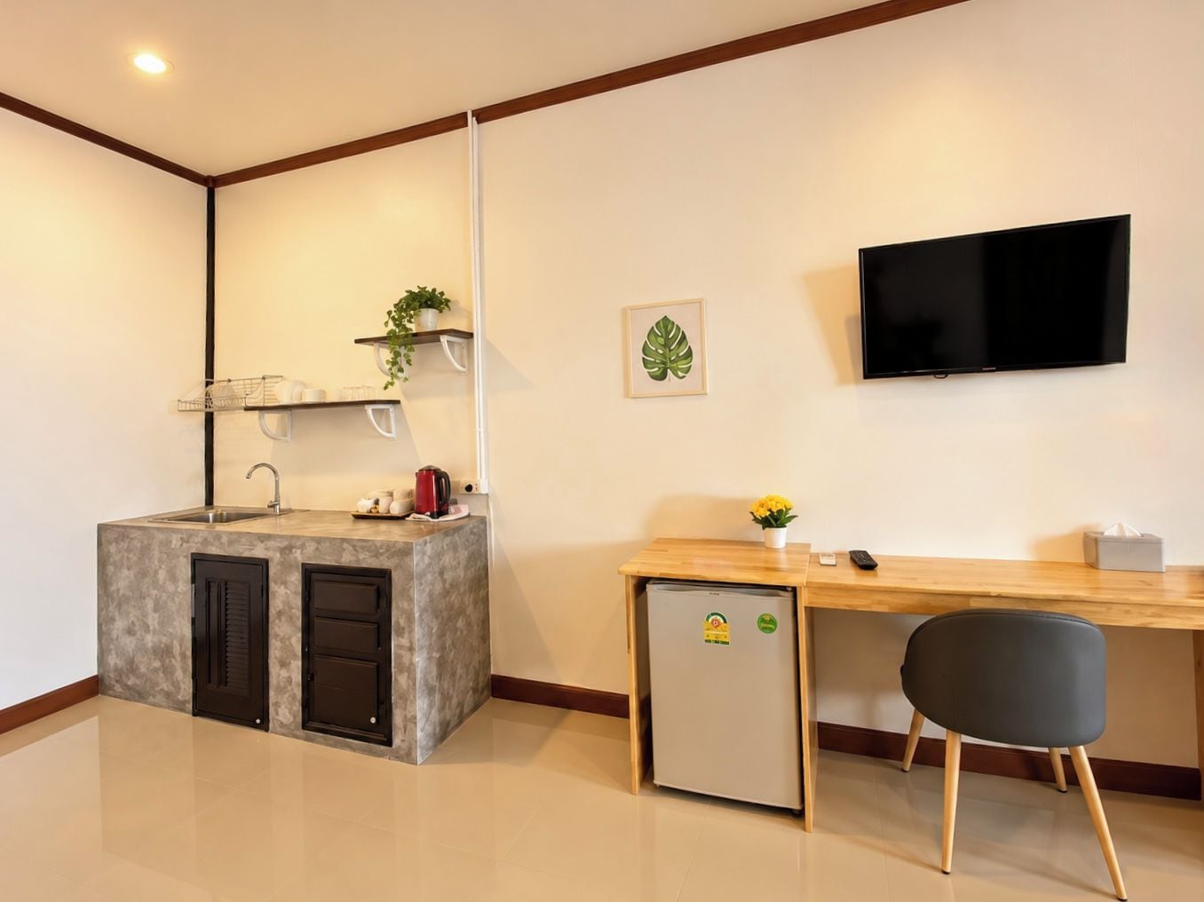 A compact kitchen with a built-in refrigerator, a sink, and a small countertop.