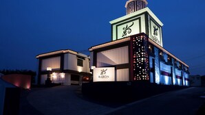 A hotel with a prominent tower and a modern facade. - Hotel Baron -the Sweet Modern - Adults Only (Togo)