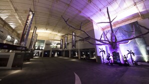 A spacious indoor area with a high ceiling and a large tree sculpture. There are signs for 'HOTEL DION' and 'MOTEL DION' with room numbers. - Hotel Dion -dreams IN Resort - Adults Only (Miyoshi)