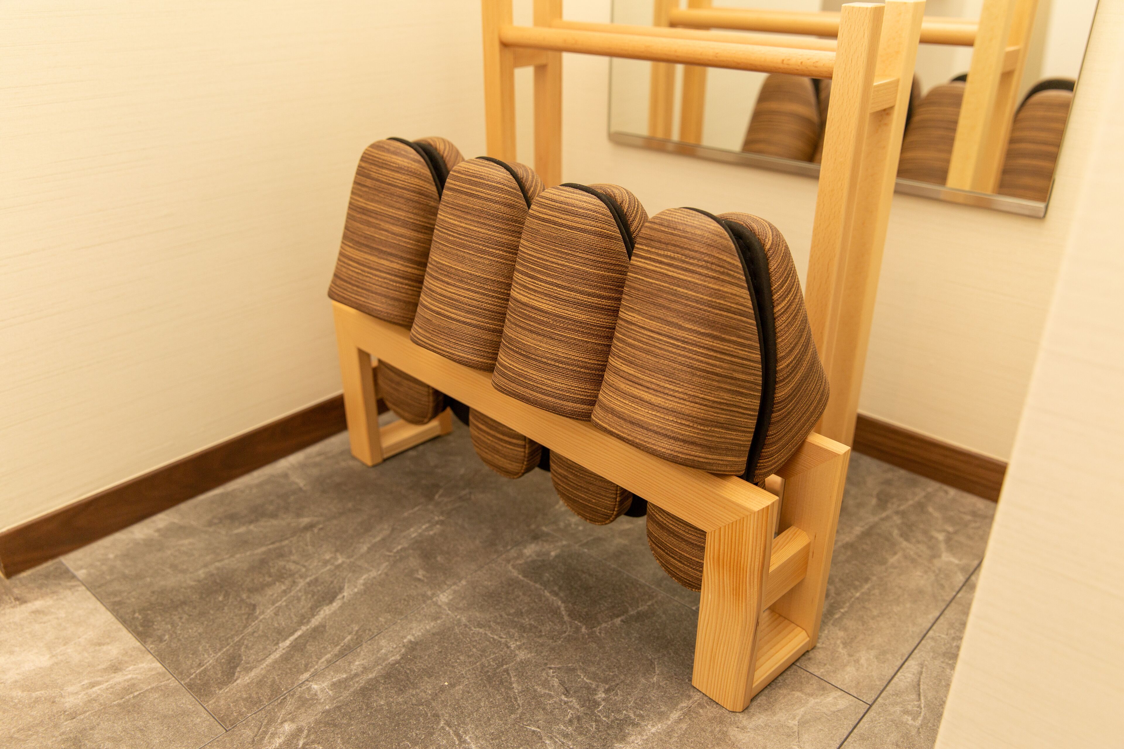 A wooden chair rail with multiple cushioned seats.