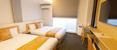 A hotel room with two beds, a desk with a chair, a TV, and a window with blinds.