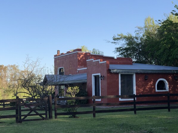 A red brick building with a flat roof and a small porch.
