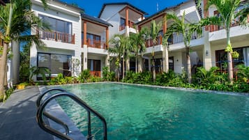 Outdoor pool, open 7:00 AM to 11:00 PM, pool umbrellas