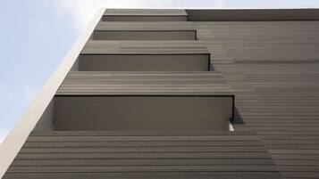 A modern building with a series of horizontal wooden panels and a flat roof.