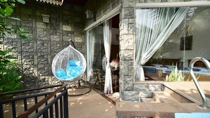 A stone building with a glass door leading to a pool area. - Thevni Holiday Resort (Ingiriya)