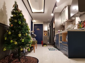 A modern kitchen with a built-in oven, a sink, and a countertop with various items. - We Home Guesthouse - Hostel (Incheon)
