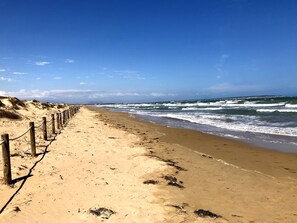 Una playa cerca, sillas reclinables de playa, toallas de playa