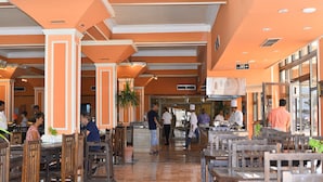 A spacious restaurant with high ceilings and a central kitchen area. - Eagle's Paradise Beach Resort Abu Soma (Safaga)