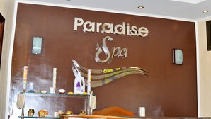 A spa wall with the words "Paradise Spa" and a decorative wave design. - Eagle's Paradise Beach Resort Abu Soma (Safaga)