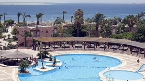 A large swimming pool with multiple lanes, surrounded by palm trees and lounge areas. - Eagle's Paradise Beach Resort Abu Soma (Safaga)