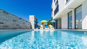 Seasonal outdoor pool, open 7:30 AM to 11:00 PM, pool umbrellas