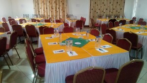 A conference room with multiple tables, chairs, and water bottles. - Taidys Suites Kericho (Kericho)