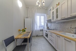 Enjoy cooking in this kitchen with an oven, sink, and cabinetry.