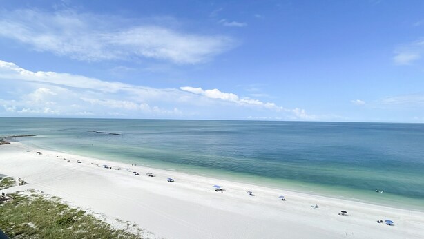 A beach with a clear view of the ocean, a sandy shore, and a few umbrellas. - BLDG Construction Aug-Oct 2026; See Desc below! Sea Winds 1203 (Marco Island)