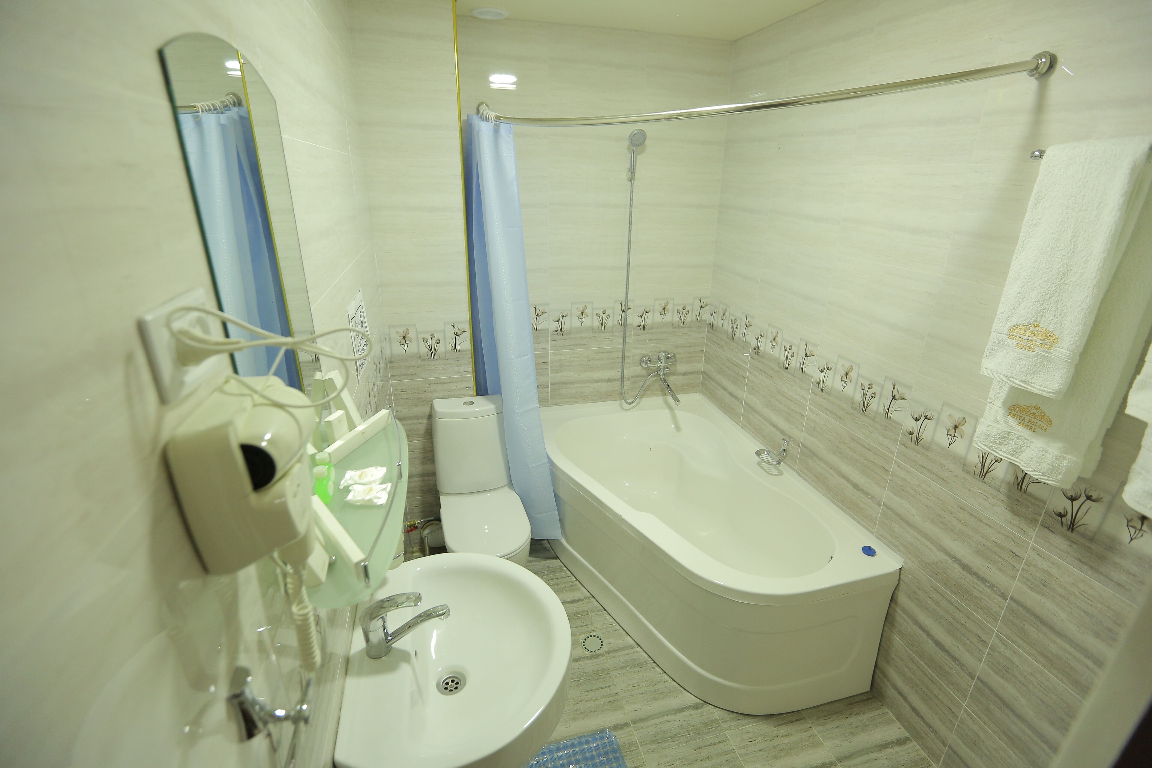 A bathroom with a bathtub, a sink, a toilet, and a shower.