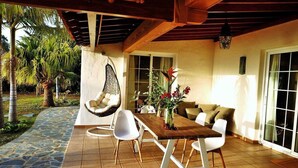 A covered patio with a dining table, chairs, a hanging chair, and a sofa. - Perseidas House, Wonderfull house with pool and sea views. (Tijarafe)