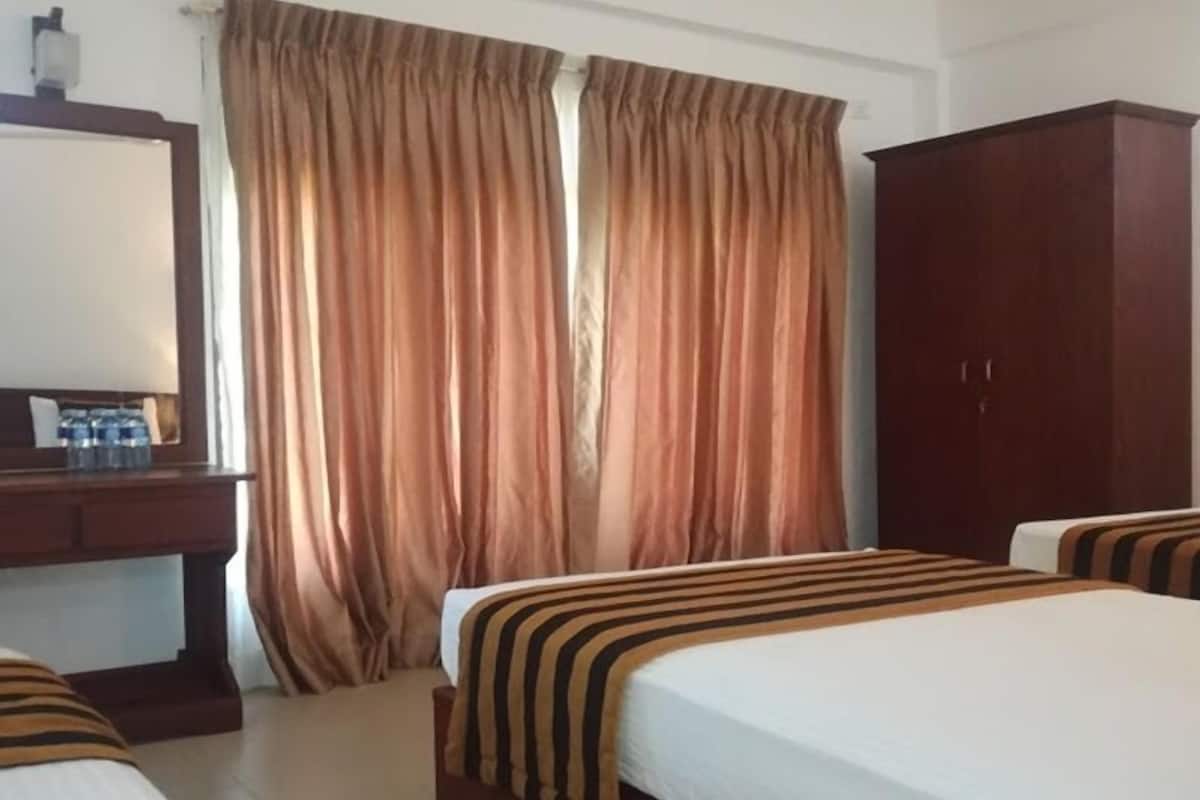 Habitación triple Deluxe, 3 camas individuales | Caja de seguridad en la habitación, wifi gratis y ropa de cama