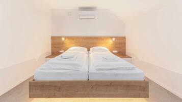 Premium bedding, memory-foam beds, desk, laptop workspace