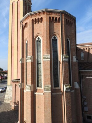 A corner building with a brick facade, arched windows, and a tower. - Hotel Centrale (Trebaseleghe)