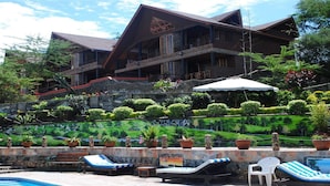 A resort with a pool area, lounge chairs, and a large building with multiple balconies. - Panorama Park Hotel (Naivasha)