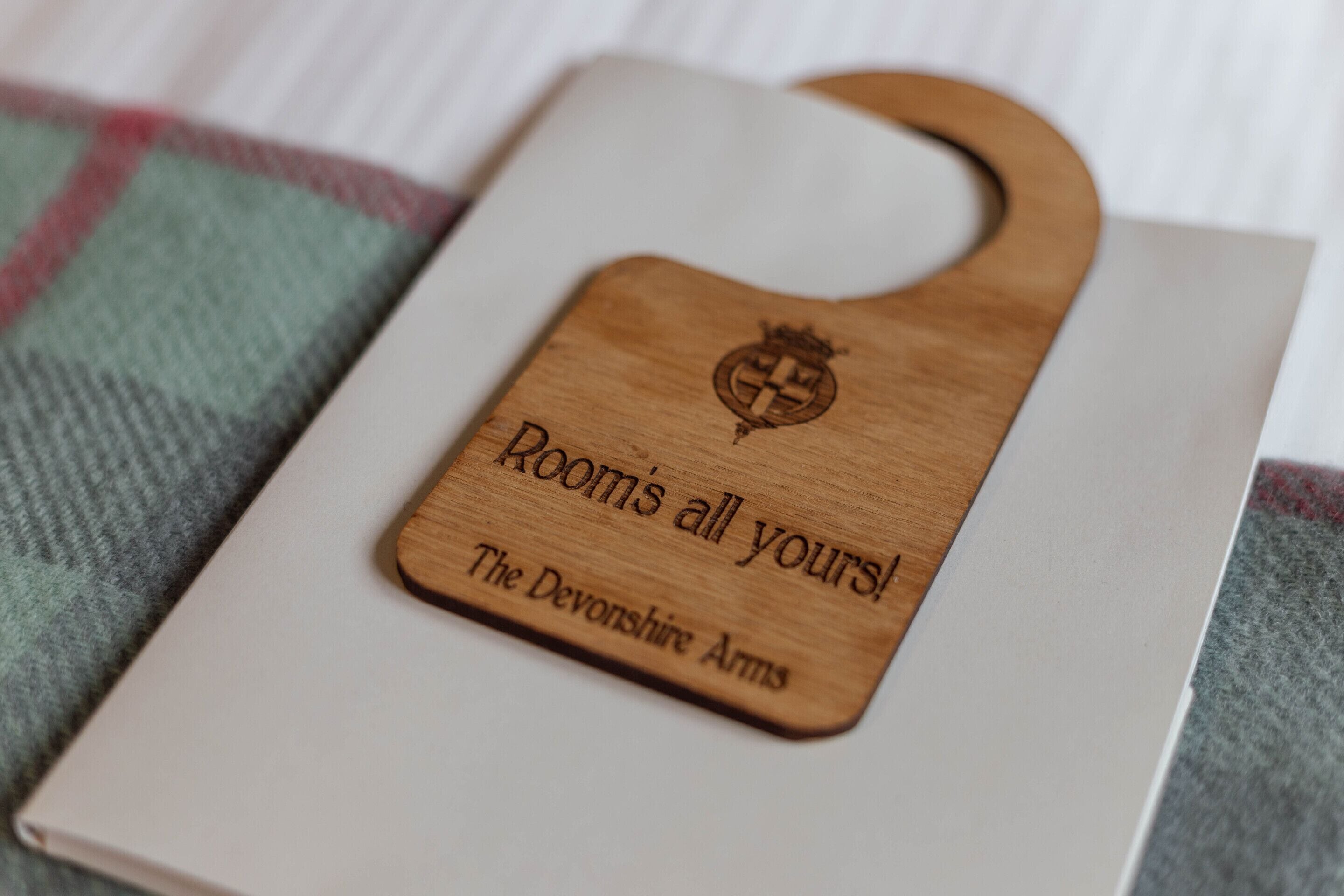 A wooden plaque with engraved text on a book.