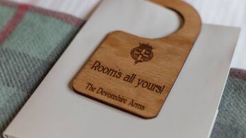 A wooden plaque with engraved text on a book.