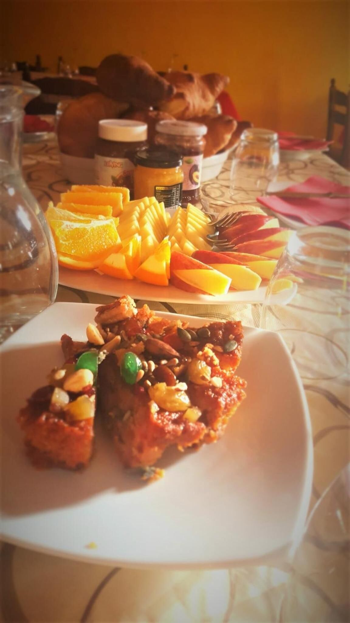 A table with a plate of food, a glass of water, and a bottle.