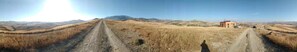 A rural landscape with a dirt road leading to a small building. - I Templari (Polizzi Generosa)