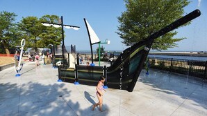 A water play area with a large ship sculpture and a fountain. - Location, Design, Indoor/Outdoor space, close to town and beach! (South Haven)