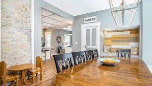 A dining area with a wooden table, chairs, and a sign labeled "PANTRY". - Location, Design, Indoor/Outdoor space, close to town and beach! (South Haven)