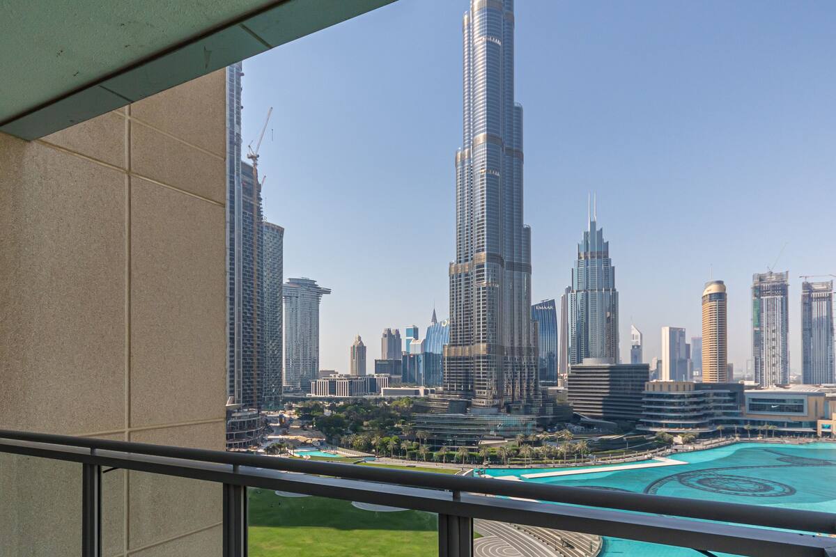 A view of the Burj Khalifa and surrounding skyscrapers from a balcony with a pool.