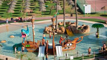 A water park with slides, a ship-themed play area, and a tennis court.
